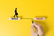 © Achmad Khoeron - Build trust symbol. Concept words Build trust on wooden blocks on a beautiful yellow table yellow background. Businessman hand. Business and build trust concept, copy space