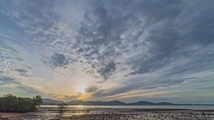 Wall Mural - Time lapse blue cloud in sunset above the sea. Nature video High quality footage Scene of romantic sky sunset with cloud over the mountain range background 
for creative nature and travel concept.