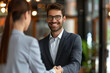 © Shakeeb - Nice to meet you in our team. Friendly man leader boss shake hand of new staff member welcome young male on job in corporate department. Professional businesspeople reached agreement on negotiations