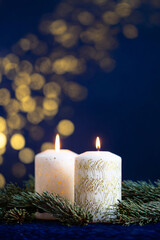 Wall Mural - A beautiful, bright, festive Christmas abstract blue background with lit candles and a bokeh effect. Shining and sparkling, vibrant. Vertical banner, copy space