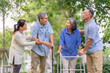 © Verin - group of older disabled people with caregiver meet in the garden,greeting,talking together,elderly friends enjoy relaxing and rehabilitation in nature