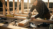 © ณภัทร วงค์มาวิวัฒน์ - Craftsman at Work: A seasoned craftsman, focused and precise, meticulously uses a circular saw to shape the wooden frame of a new construction project.