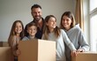 © Thomas - Happy family with cardboard boxes in new house at moving day. Mortgage, family, real estate concept. High quality