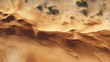 Aerial view of desert sand dunes textured landscape with sparse vegetation