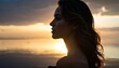© ruangrit19 - Serene Woman Silhouetted Against Sunset Ocean.