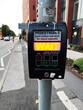Pedestrian crossing signal button on urban street,  UK