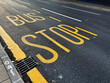 Bus stop road marking on asphalt in Manchester UK urban street scene