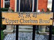 Wooden address sign reading 37 39 41 Upper Chorlton Road in Manchester UK