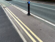 Urban street scene in Manchester UK showing a cycle bollard and double yellow lines
