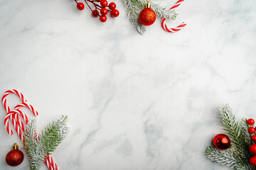 Wall Mural - christmas and new year background with candy canes with holiday decorations and fir branches on a ma