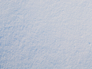 Wall Mural - Natural snow texture. The surface of clean fresh snow. Snowy ground. Winter background with snow patterns. Perfect for Christmas and New Year design. Closeup top view.