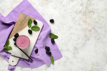 Wall Mural - Glass of fresh blackberry smoothie with mint and berries on white background