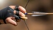 © AudaX - Close-up of an archer's hand in a leather glove drawing a bow and arrow.
