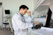 © fizkes - Overworked stressed male doctor sit by computer with closed eyes