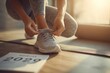 © ant - young woman tying sneakers, fitness mat beside, planner page 2026 Resolution visible, morning light