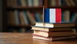 © Aleksandra Prokopenk - French flag on a stack of books, symbolizing French education or literature. Includes space for text. Ideal for academic, cultural, and language learning materials.