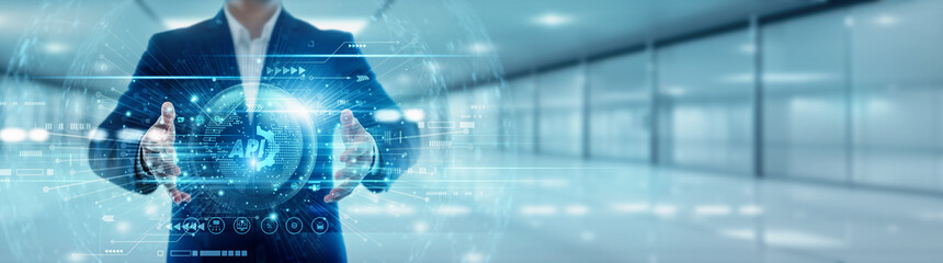 The API person holds a global interface globe with a network connected to API integration data exchange software connection protocol development functionality service application interaction digital.