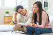 © KMPZZZ - Stressed financial owe asian young couple love sitting suffer, stressed and confused by calculate expense from credit card bill, no money to pay, mortgage or loan. Debt, bankrupt or bankruptcy people.