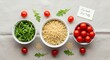 © Таня Андреева - Fresh quinoa, cherry tomatoes and arugula leaves in white bowls with 'Eat Well Live Fully' note. Clean eating and healthy lifestyle concept.