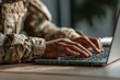 © Vlad - Military Using Computer. Cropped View of Soldier in Camouflage Uniform on Laptop Table