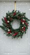 © Volha - Holiday wreath decorated with pinecones and berries on door