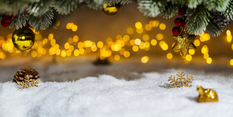 Wall Mural - christmas holiday background with snow, fir tree and decorations with christmas light behind. christ