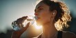 © satisfied - Hydration and Fitness: Woman Rehydrates After Workout