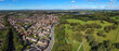 Wide panorama of Prestwich housing, Metro-link line, and Heaton Park green fields in Manchester.