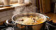 © Lubov - Pot of steaming soup simmering on the stove in cozy kitchen