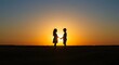 © Norul Amin - Silhouette of children holding hands at sunset on a hilltop, symbolizing unity and hope
