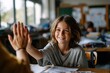 © AspctStyle - Smiling schoolchild giving a high five to a teacher while sitting at a classroom desk with books and papers, showing encouragement and positive learning atmosphere