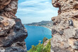 View of Alanya coast from the historic Alanya Castle, Turkey. The Mediterranean Sea, surrounding mountains, and a boat are visible on a sunny day
