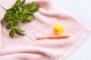 Wall Mural - toothbrush with terry cloth health care of baby arrangement flat lay style on background white 