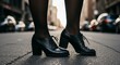 Woman's black leather oxford heels on city street.