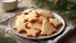 © Alena - Christmas cookies on a decorative plate with tea and pine branches on table. buttery shortbread cookies shaped like stars and trees on a vintage plate, warm cozy holiday Christmas