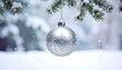 © ala - Silver Christmas ornament in snow