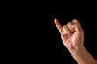 © Dibyendu - Close-Up of Hand Making a Gesture with Showing only Little Finger Raised on a Black Background