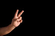 © Dibyendu - Hand Displaying Peace Gesture Against Black Background