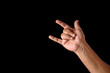 © Dibyendu - Hand Showing Rock Gesture on a Black Background for Conceptual Use