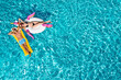 © New Africa - Happy couple with inflatable ring and mattress in swimming pool, top view. Summer vacation