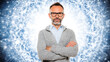 © Allie - Man with glasses and beard standing confidently with arms crossed against a digital blue background