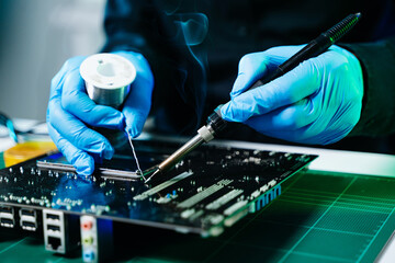 The technician repairing the motherboard in the lab with copy space. the concept of computer hardware, mobile phone, electronic, repairing, upgrade