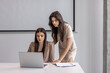 © rilueda - Two businesswomen working on laptop together