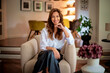 © sepy - Confident middle-aged woman relaxing in her modern home