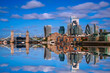 London City skyline reflected on the River Thames, a tranquil metropolitan beauty with modern high-rising architecture and Tower Bridge in the heart of the United Kingdom.
