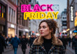 © Anuyj - Stylish beautiful young woman in brown jacket with shopping bags in the city with shopping mall in the background. Shopping concept. Black Friday.