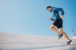 © muse studio - Runner ascends outdoor steps in athletic gear during fitness routine