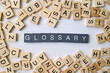 © Ployker - Glossary word in wooden cube blocks, dictionary definition concept, list of terms and meanings, education and knowledge idea