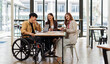 © David - Asian Male Manager On A Wheelchair Sitting With His Colleagues At Workplace