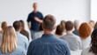 © 69 - Engaged Audience Attending Presentation in Modern Conference Room with Focus on Speaker and Diverse Attendees in Professional Setting